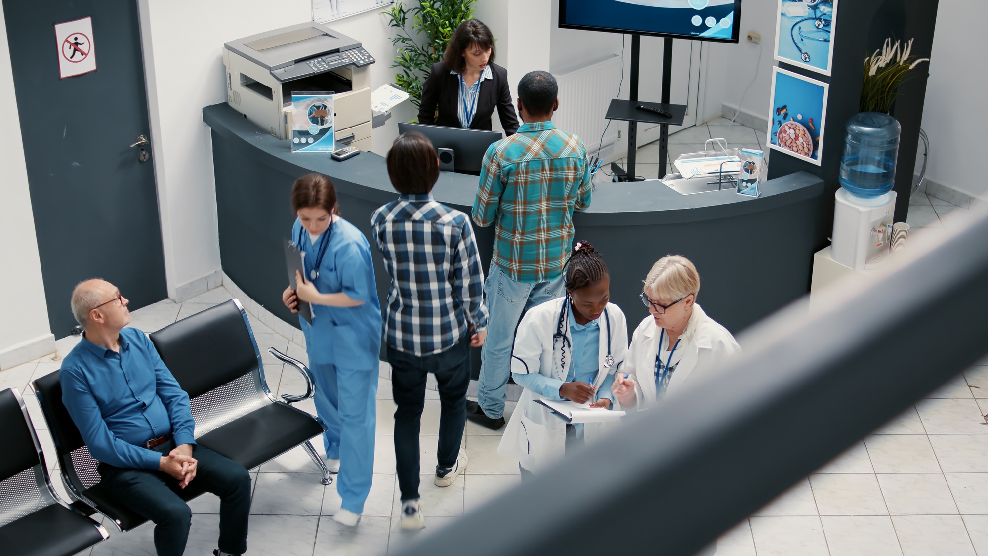 Senior doctor and african american medic talking in hospital reception