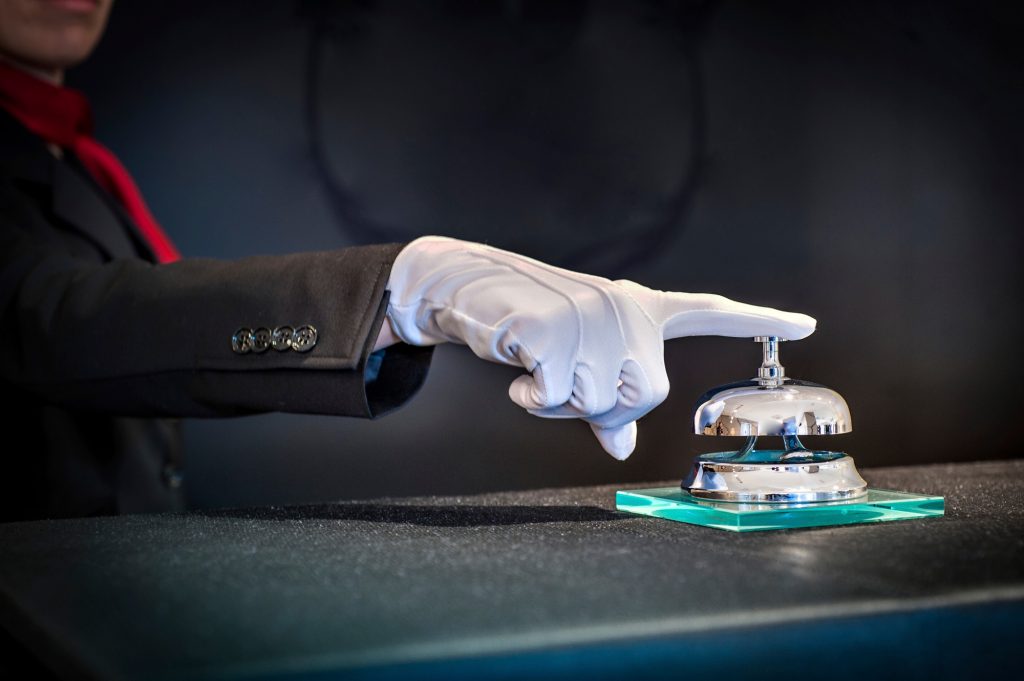 Concierge ringing reception bell